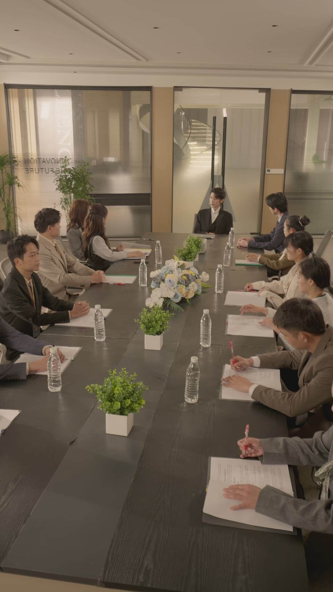 Shen Haonan as Xin Qi hosting a business meeting in Episode 71 of All My Love For You Chinese micro-drama on Viu