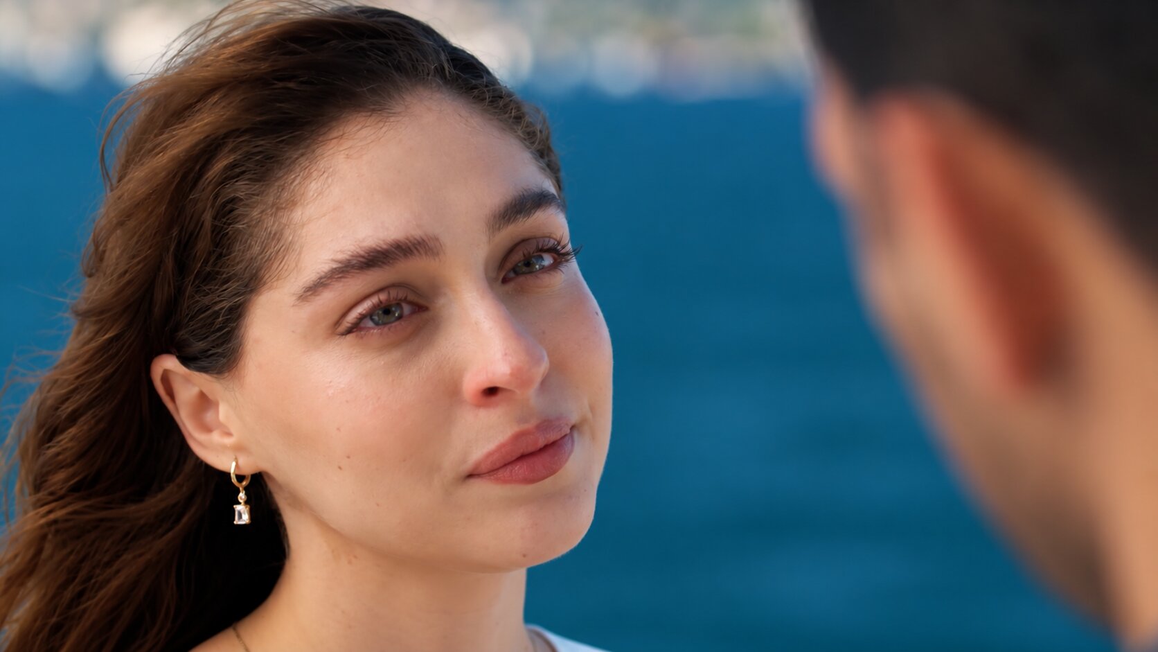 Front shot of Cemre Baysel as Zeynep Candan looking emotional with teary eyes opposite Murat Yıldırım as Serhat Tecer in Sins and Roses Season 2 (Güller ve Günahlar / Woroud Wa Thonoub).